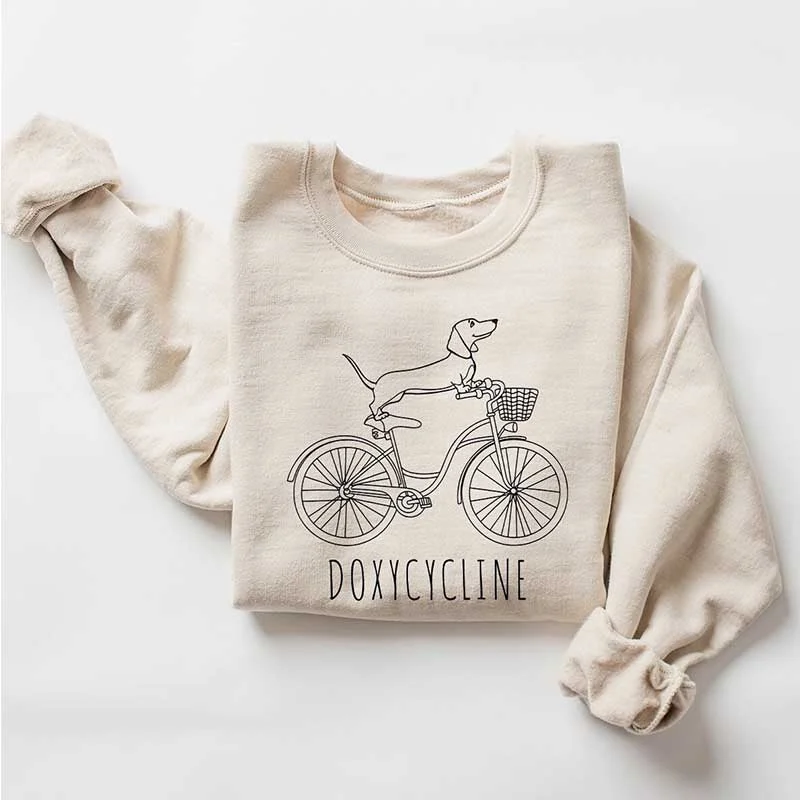 Sweatshirt with thin hem -Doxycycline Dachshund on Bicycle Sweatshirt